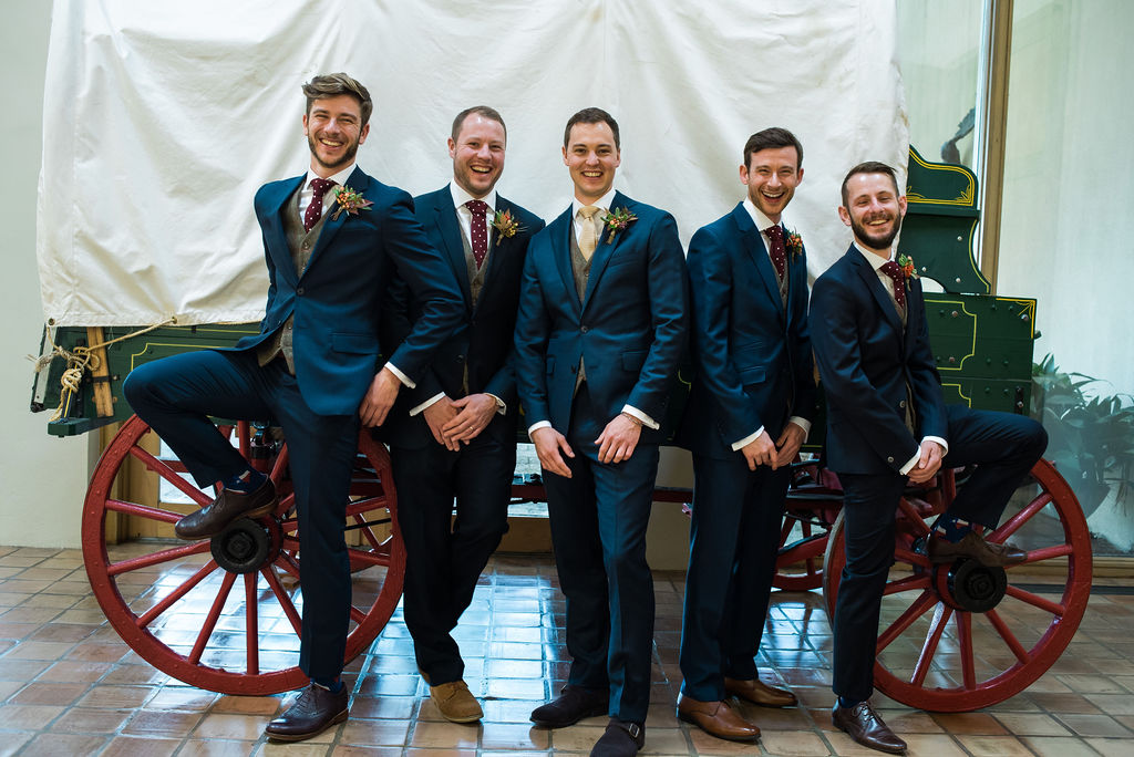groomsmen in front of a wagon