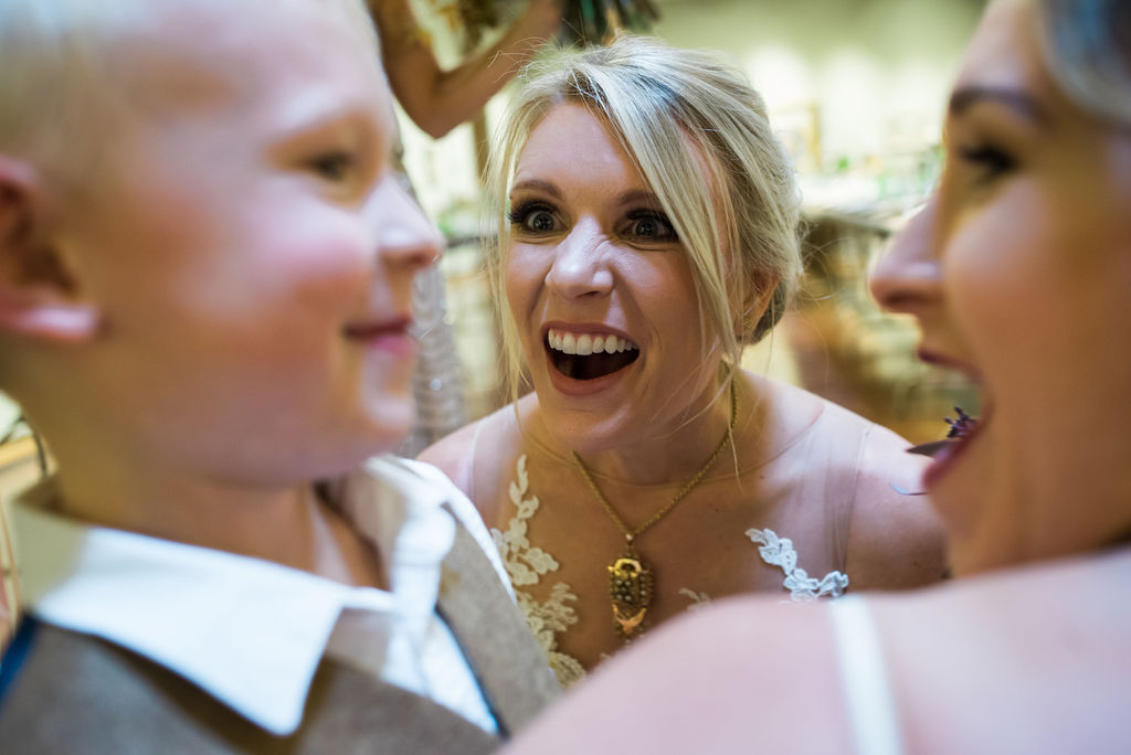 a bride looks at her nephew with happiness