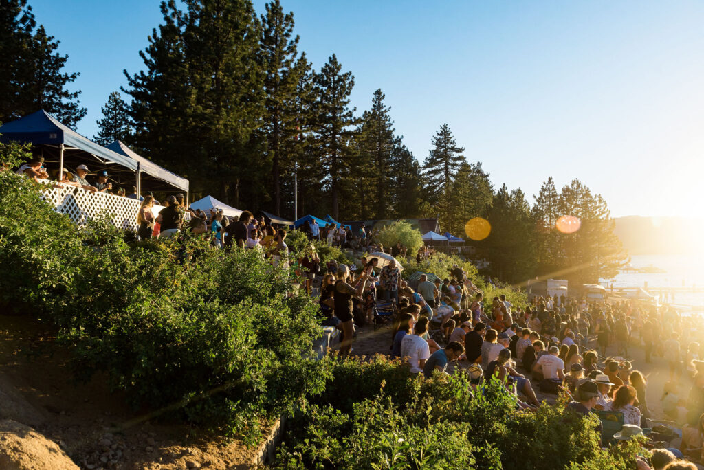 LiveAtLakeview_072723-134 Large crowd enjoying a summer evening concert at Live at Lakeview in South Lake Tahoe, with live music, food vendors, and scenic lake views at sunset
