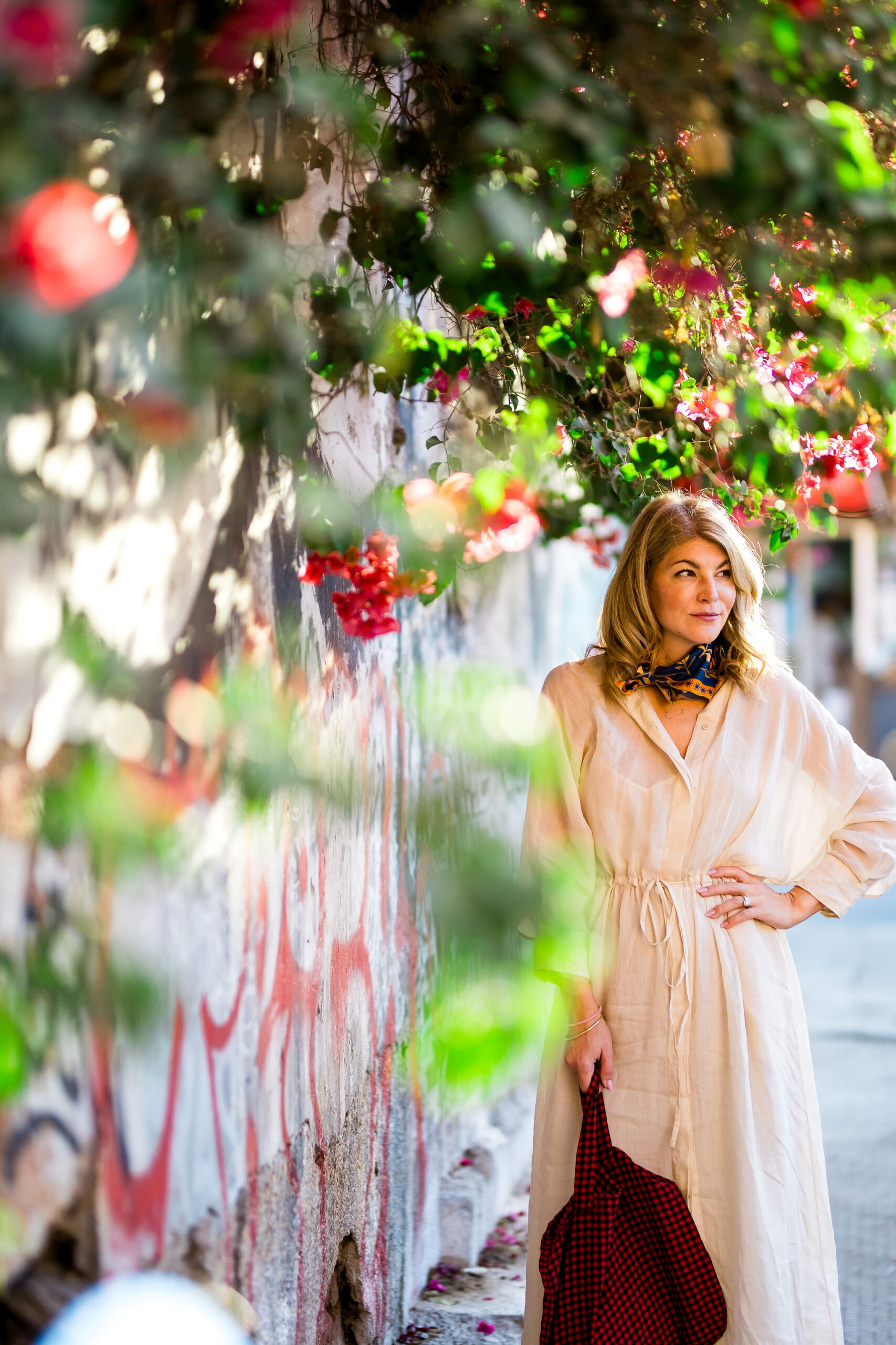 Woman poses with flower wall