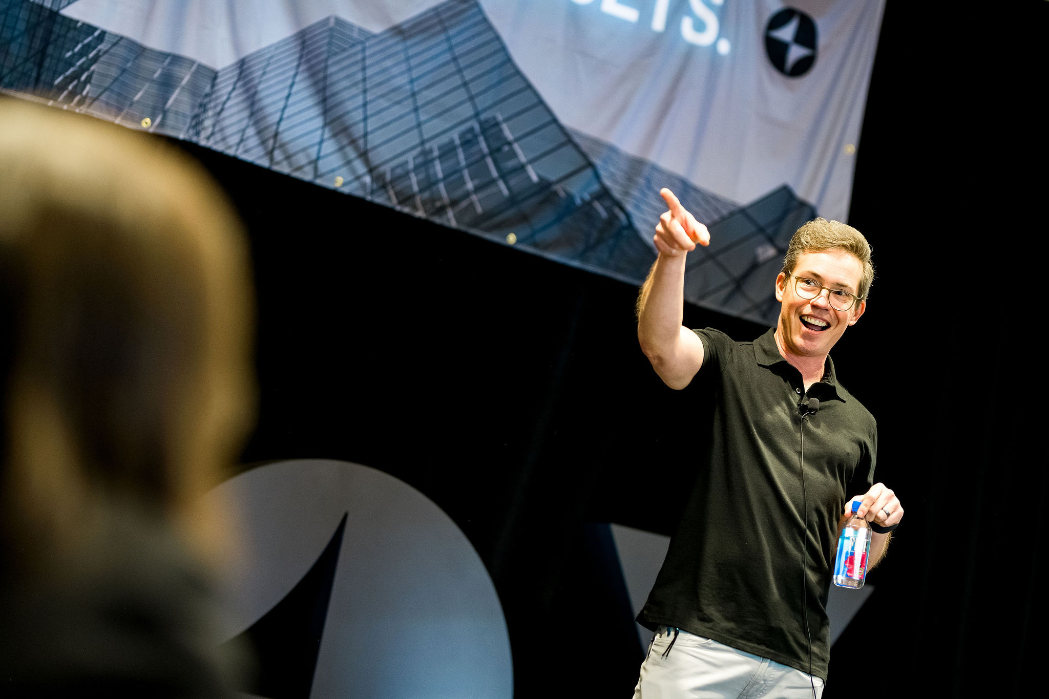 Conference speaker makes a grand gesture with maximum impact during a corporate event presentation