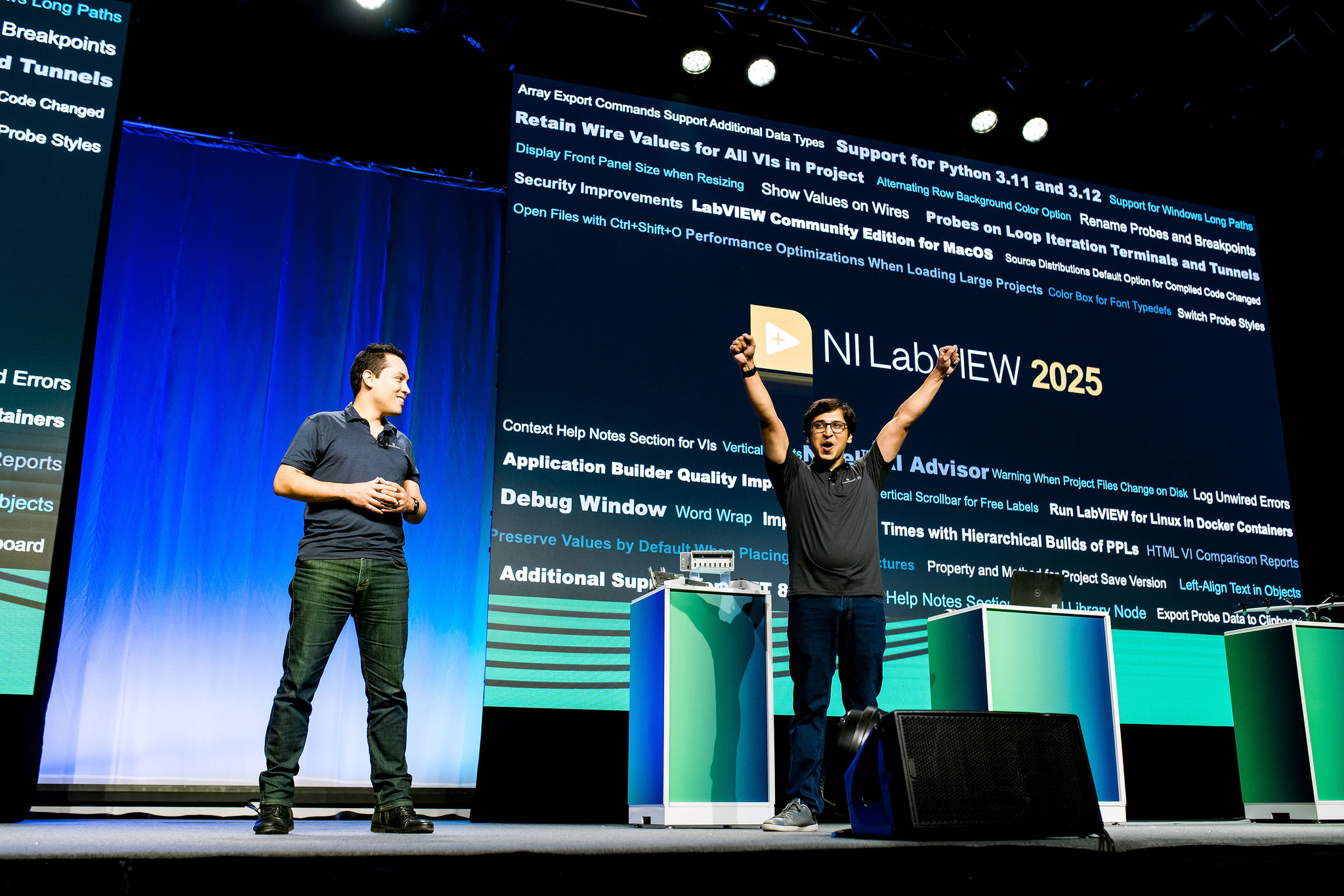 Speakers standing in stage lighting at professional conference
