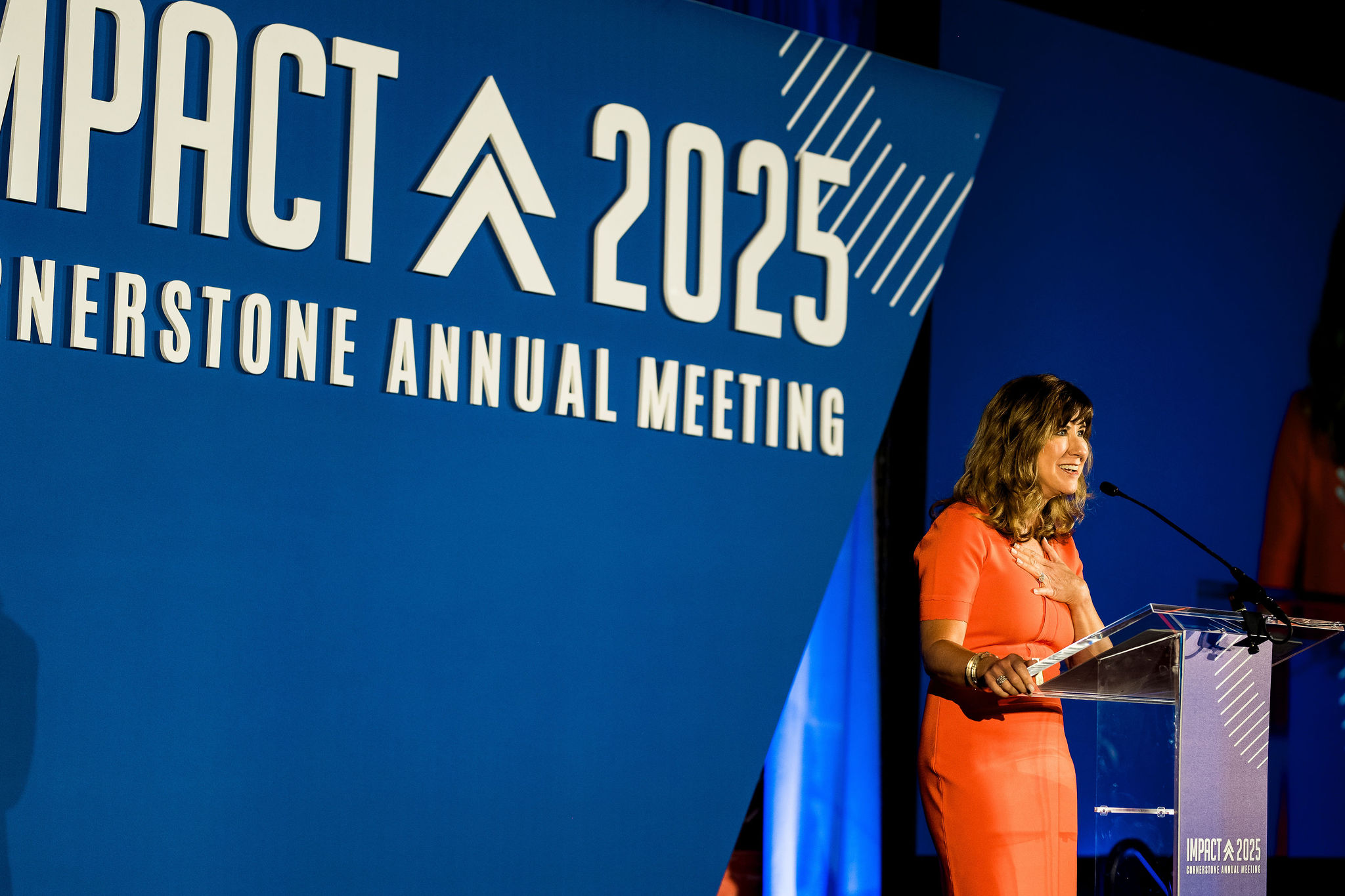 Conference speaker addressing audience during keynote presentation